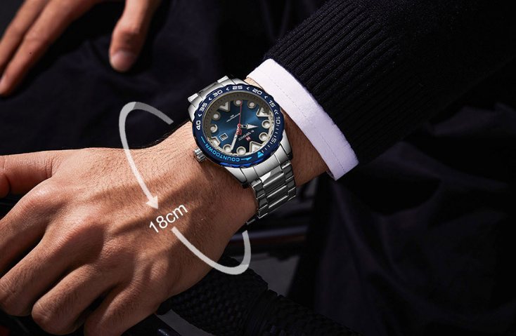 Close-up of a wrist wearing a silver watch with blue accents, showing the band size.
