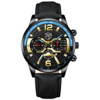 A black DEYROS branded analog quartz watch with a black band and a black dial with gold and silver accents, blue and red needles, and a date display.