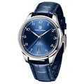 A blue mechanical watch with a round dial, stainless steel case, pin buckle, and a blue leather strap.