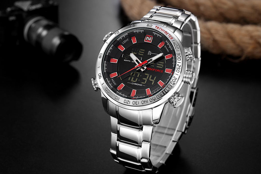 Silver wristwatch with a black face and red accents on a dark background