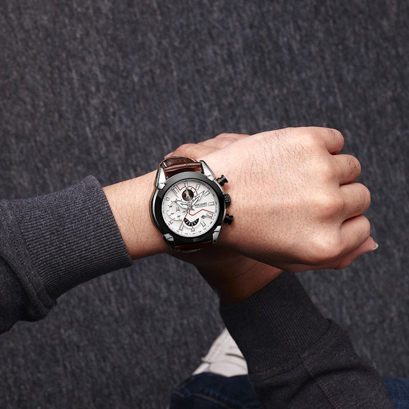 Hand wearing a detailed wristwatch on a dark textured background