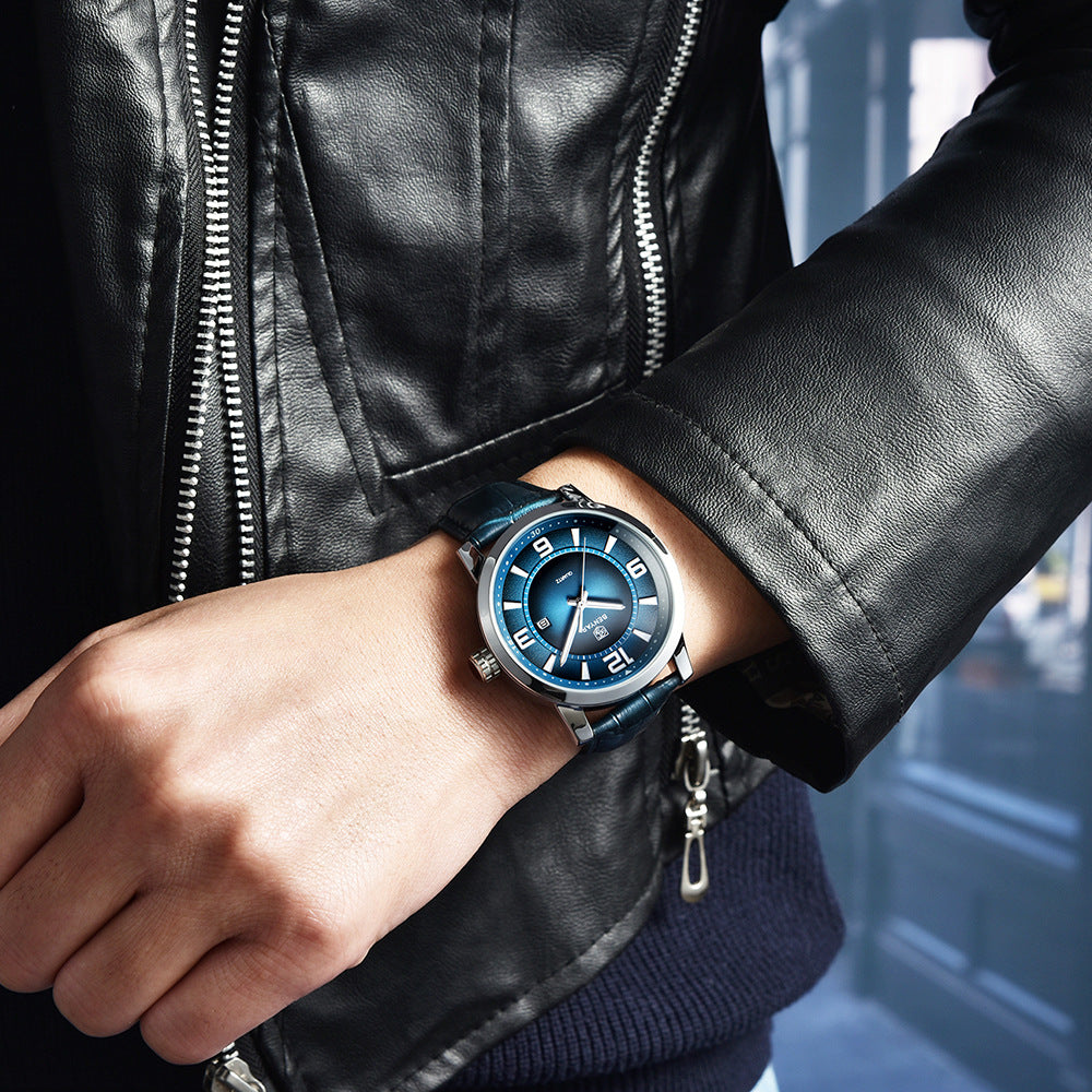 Person wearing a black leather jacket with a blue wristwatch on a blurred street background