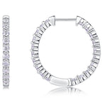 Silver hoop earrings with diamond accents on a white background