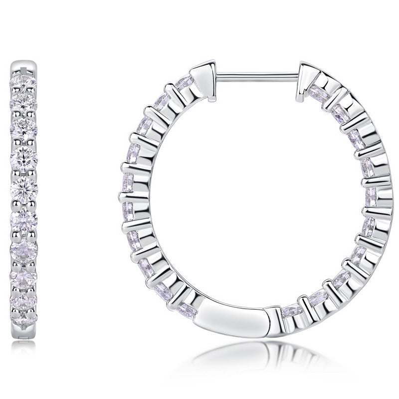 Silver hoop earrings with diamond accents on a white background
