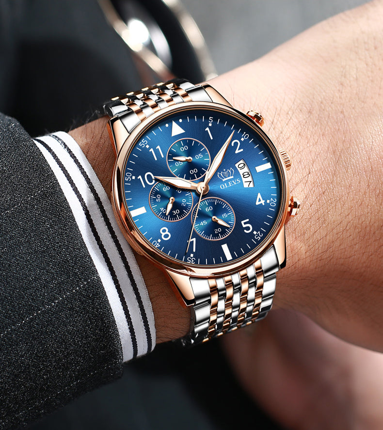 Luxury watch with blue dial and rose gold case on a wrist.