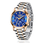 Luxury watch with blue dial and rose gold accents on a white background