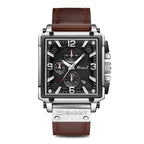 A men's square-shaped watch with a brown leather band and rose gold case, featuring a black dial with indicator needles and a spiral crown.